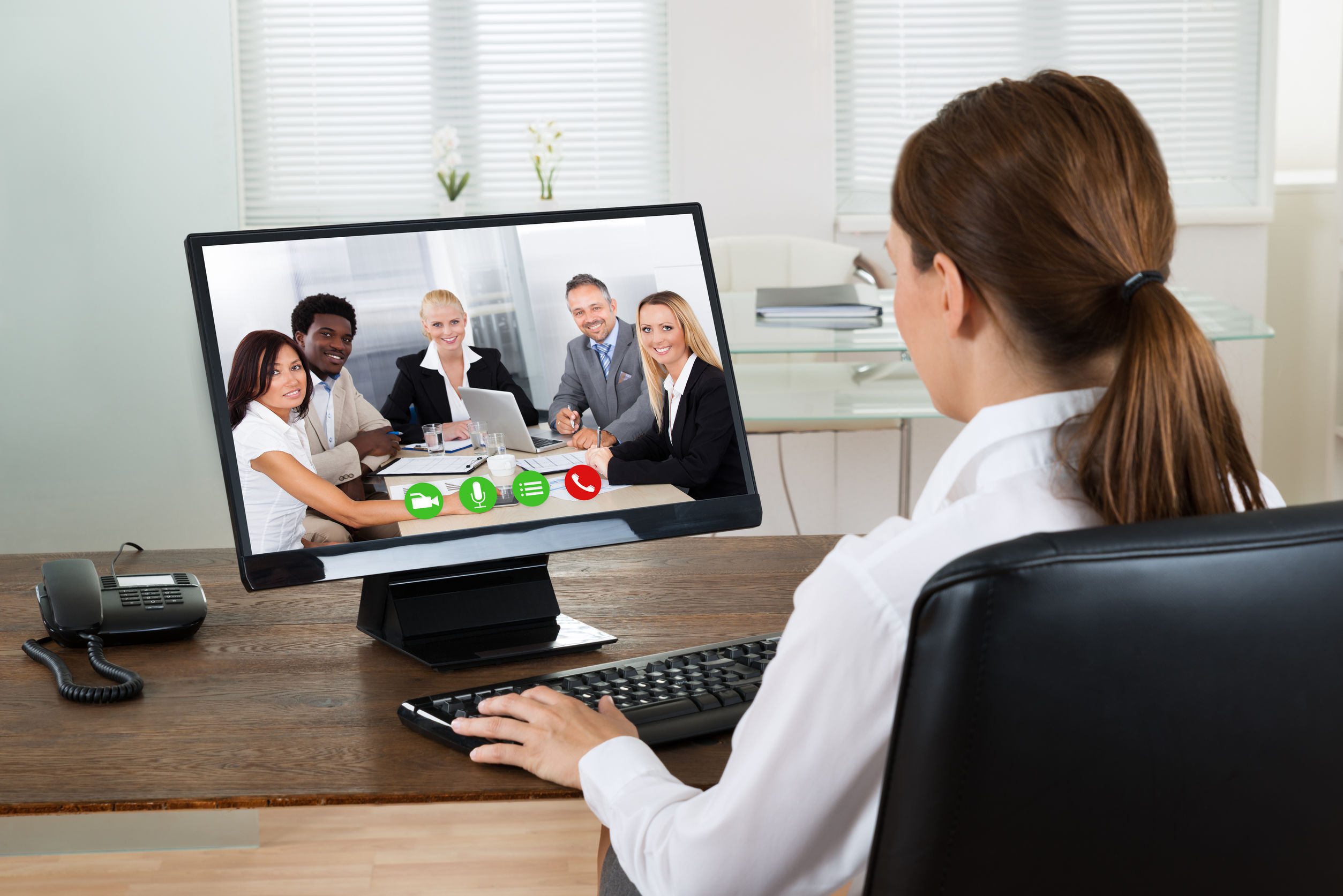 Businesswoman Videochatting With Colleagues On Computer