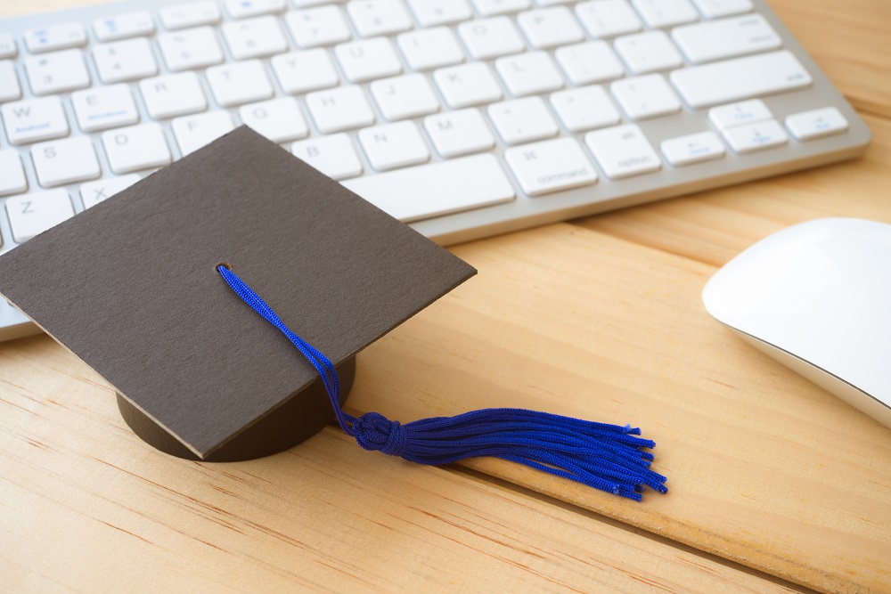 Graducate cap on keyboard with mouse, E-learning online education concept