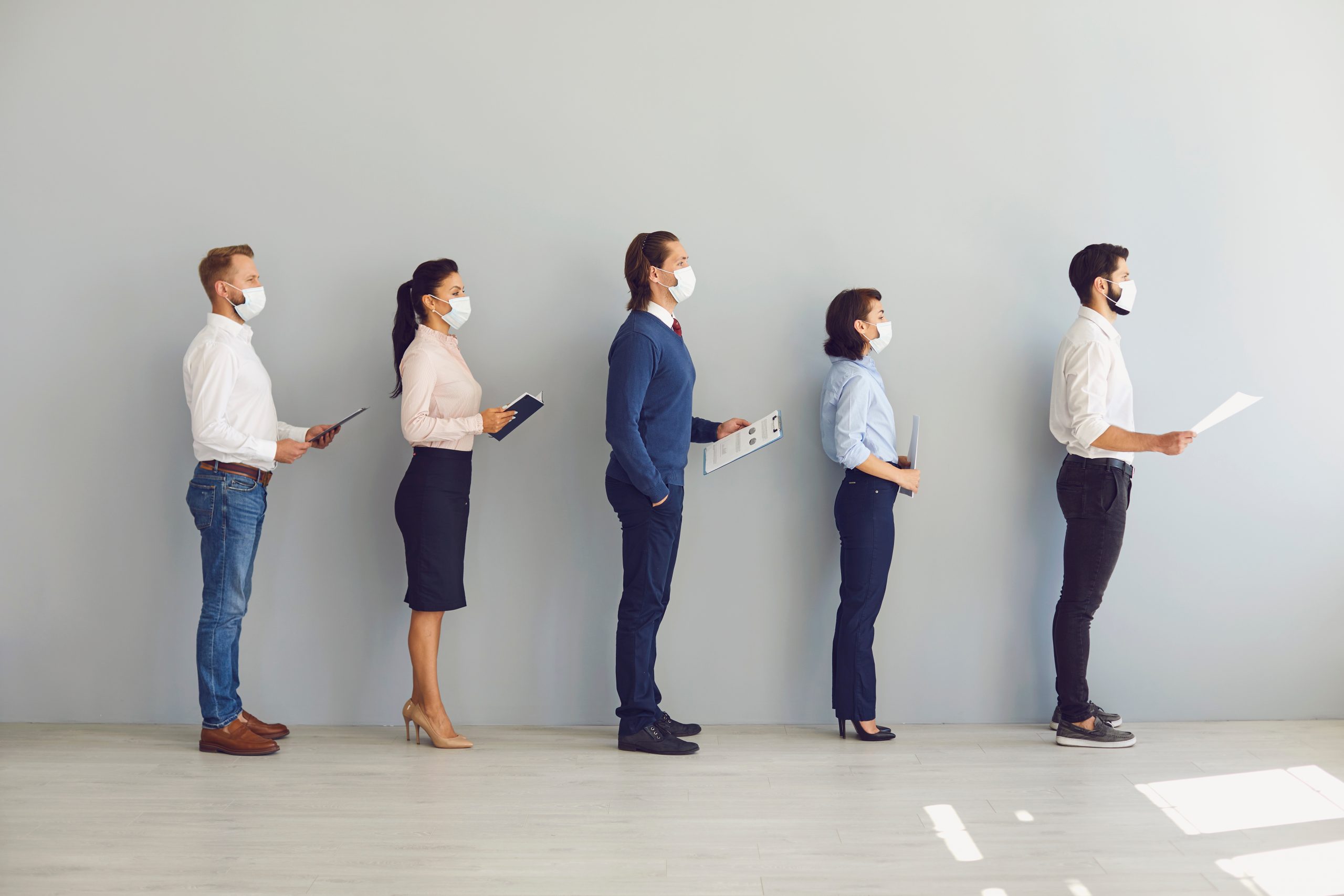 Job candidates waiting in line with face masks on.