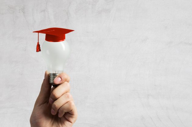 Lightbulb with graduation cap on