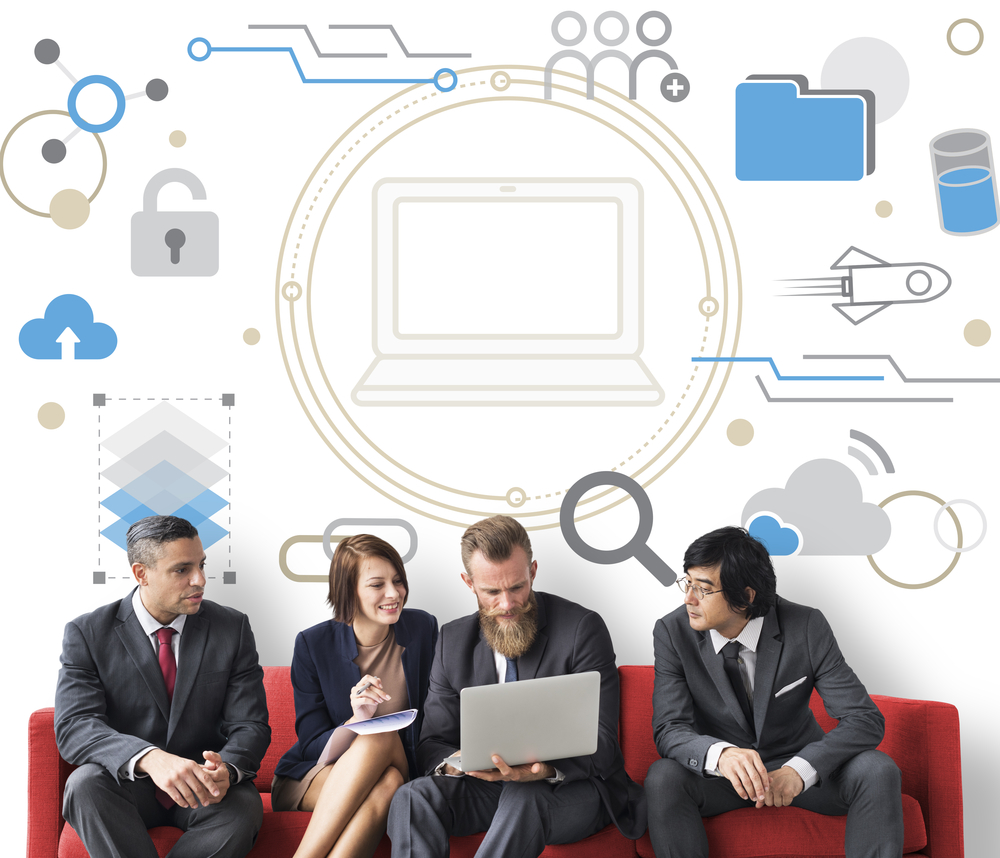 Group of professionals gathered around laptop on red couch