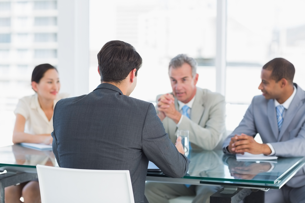 Multi-race recruiters checking candidate credentials